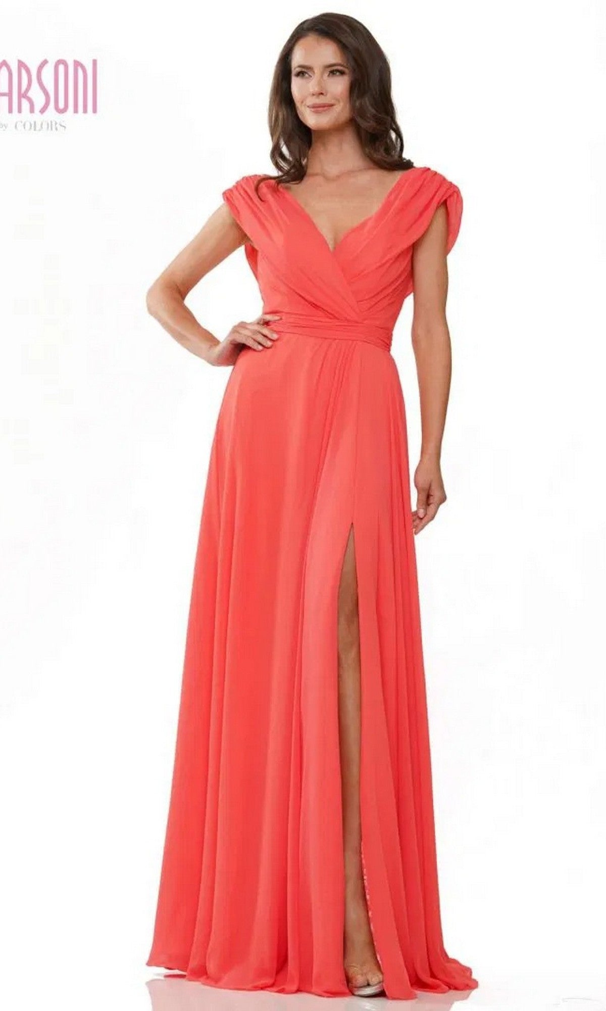 A woman wears the Marsoni M251 long formal dress in coral, featuring chiffon fabric, cap sleeves, a V-neckline, and a high slit, standing against a white background.
